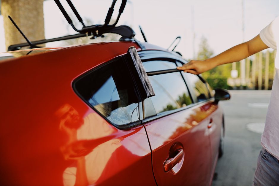 Technician cleaning a newly installed car window